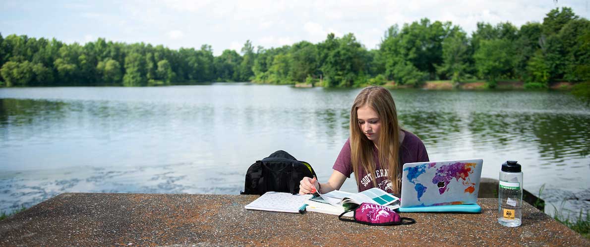 SIU Student Working by Campus Lake